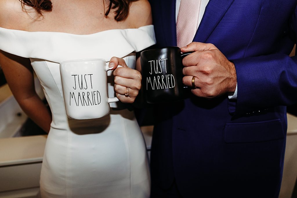 bride and groom holding bride and groom coffee mugs