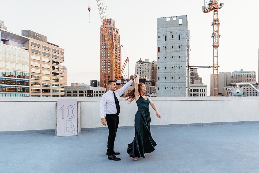 couple dancing on top of parking garage rooftop