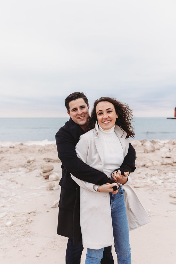 couple hugging during winter engagement photoshoot