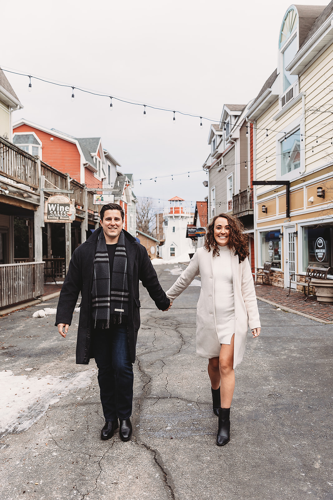 couple walking holding hands during winter engagement photos