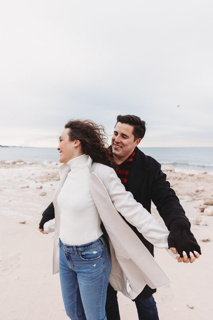 couple hugging during winter engagement photoshoot