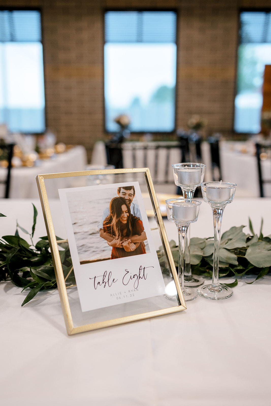 bride and groom picture in a frame on their wedding table Port 393 Wedding In Holland, Michigan | Allie + Ryan