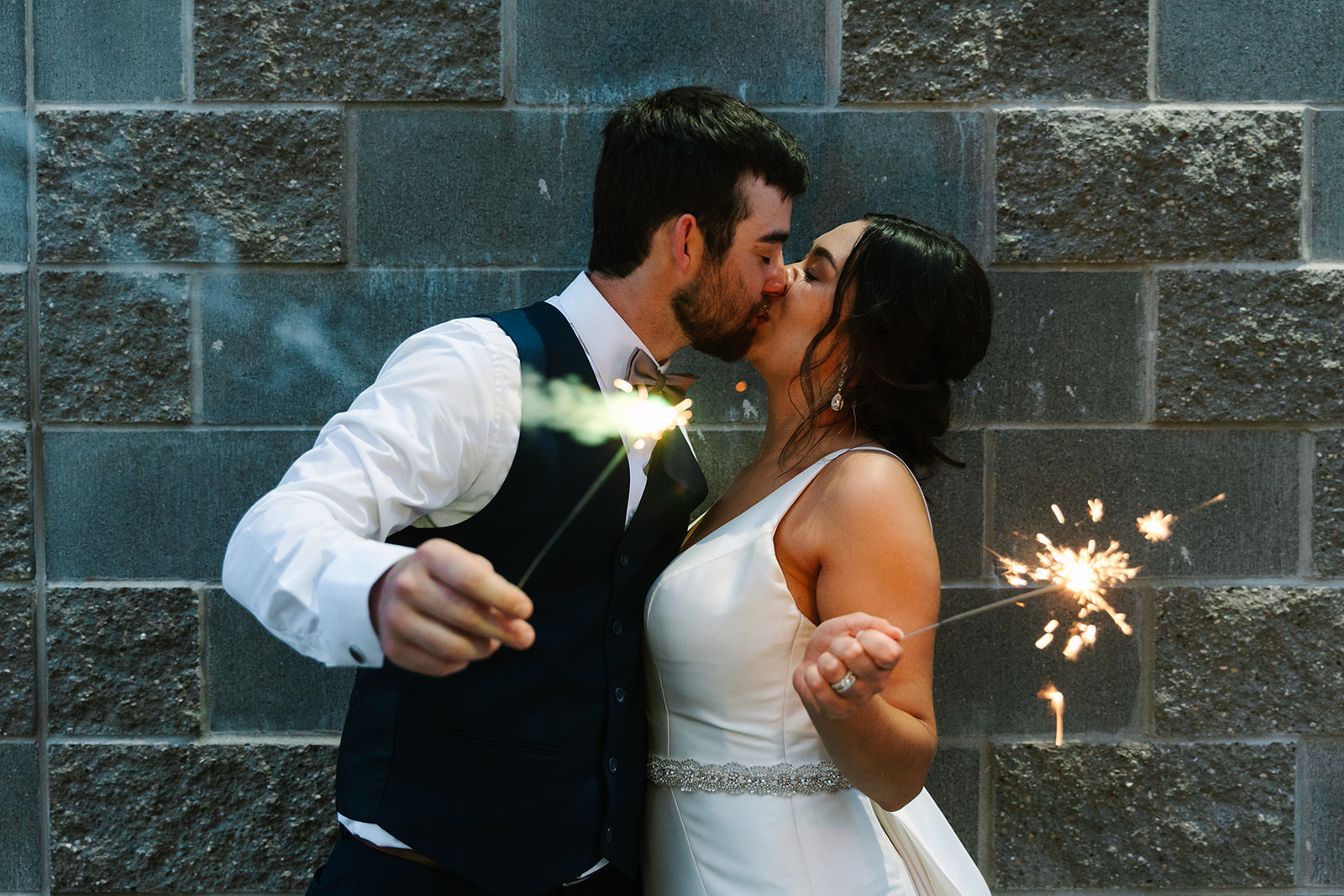 bride and groom holding sparklers with Michigan wedding photographer