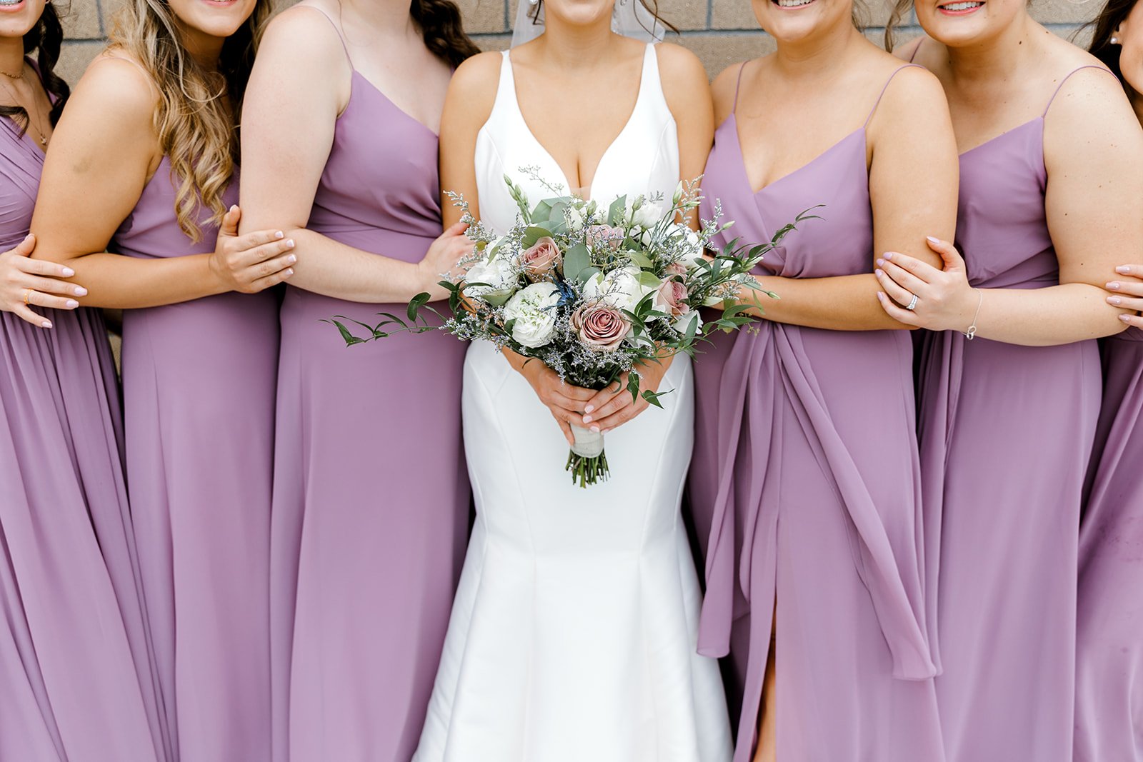up close photo of brides maids with wedding bouquet