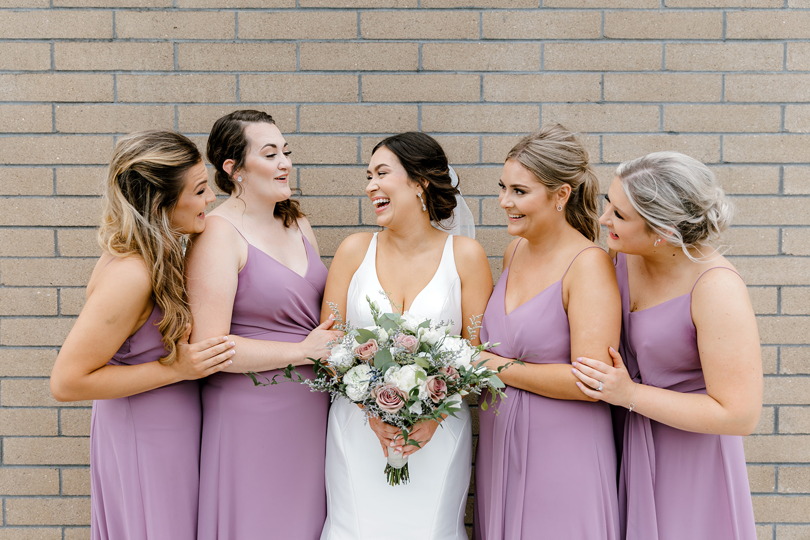 bridesmaids laughing at eachother