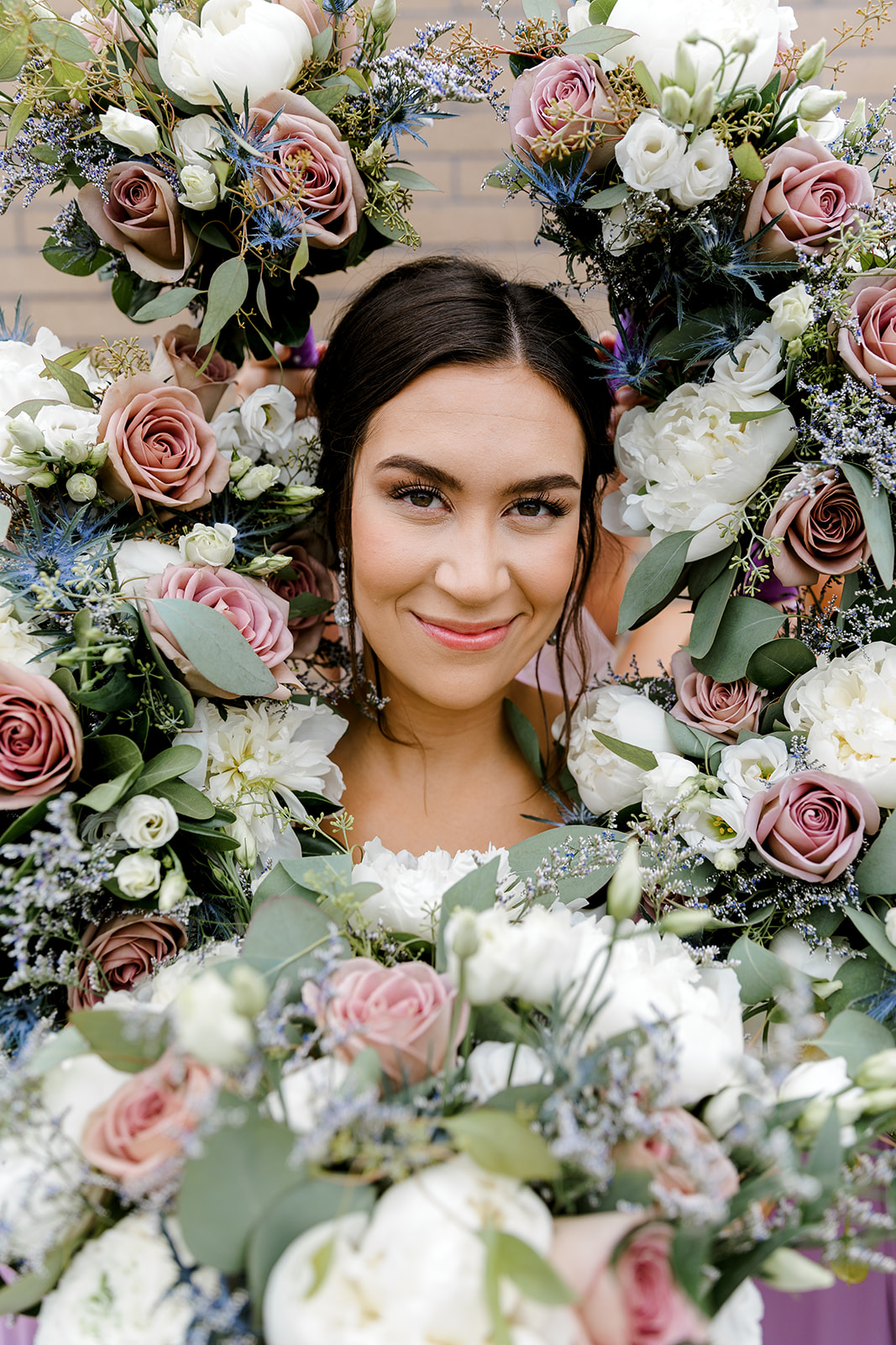 bride posing with bridal bouquets around her head Port 393 Wedding In Holland, Michigan | Allie + Ryan