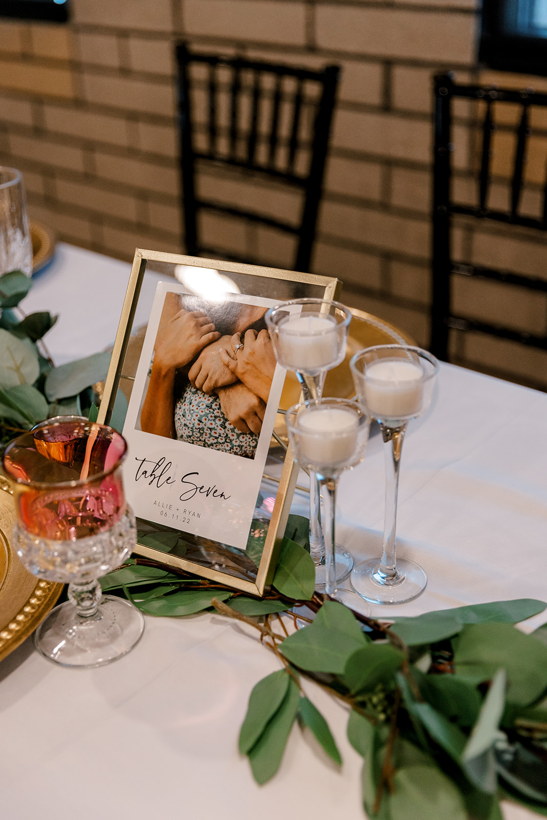 detail shot of a picture frame and champagne on a wedding table