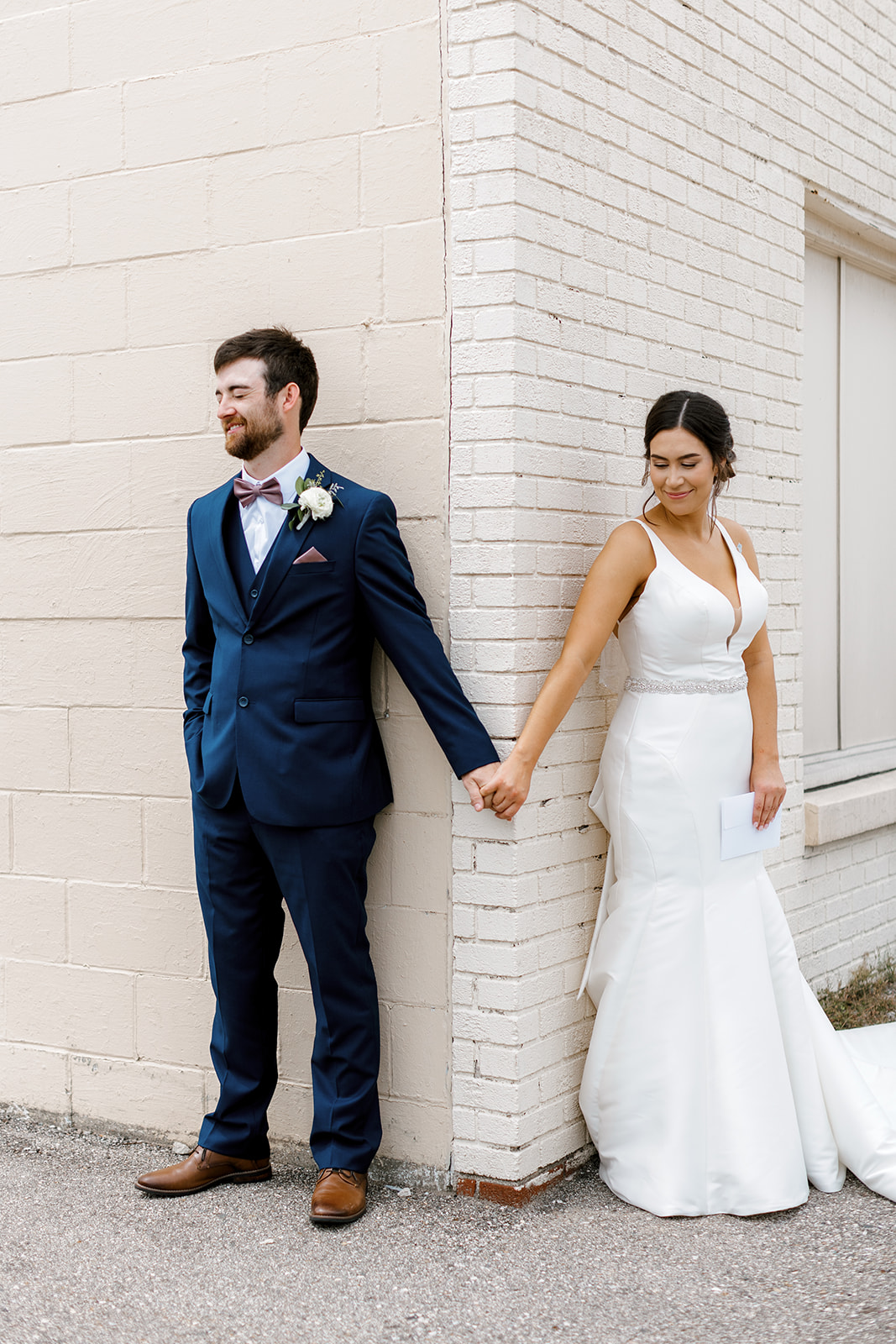 bride and groom holding hands for first look with Michigan wedding photographer