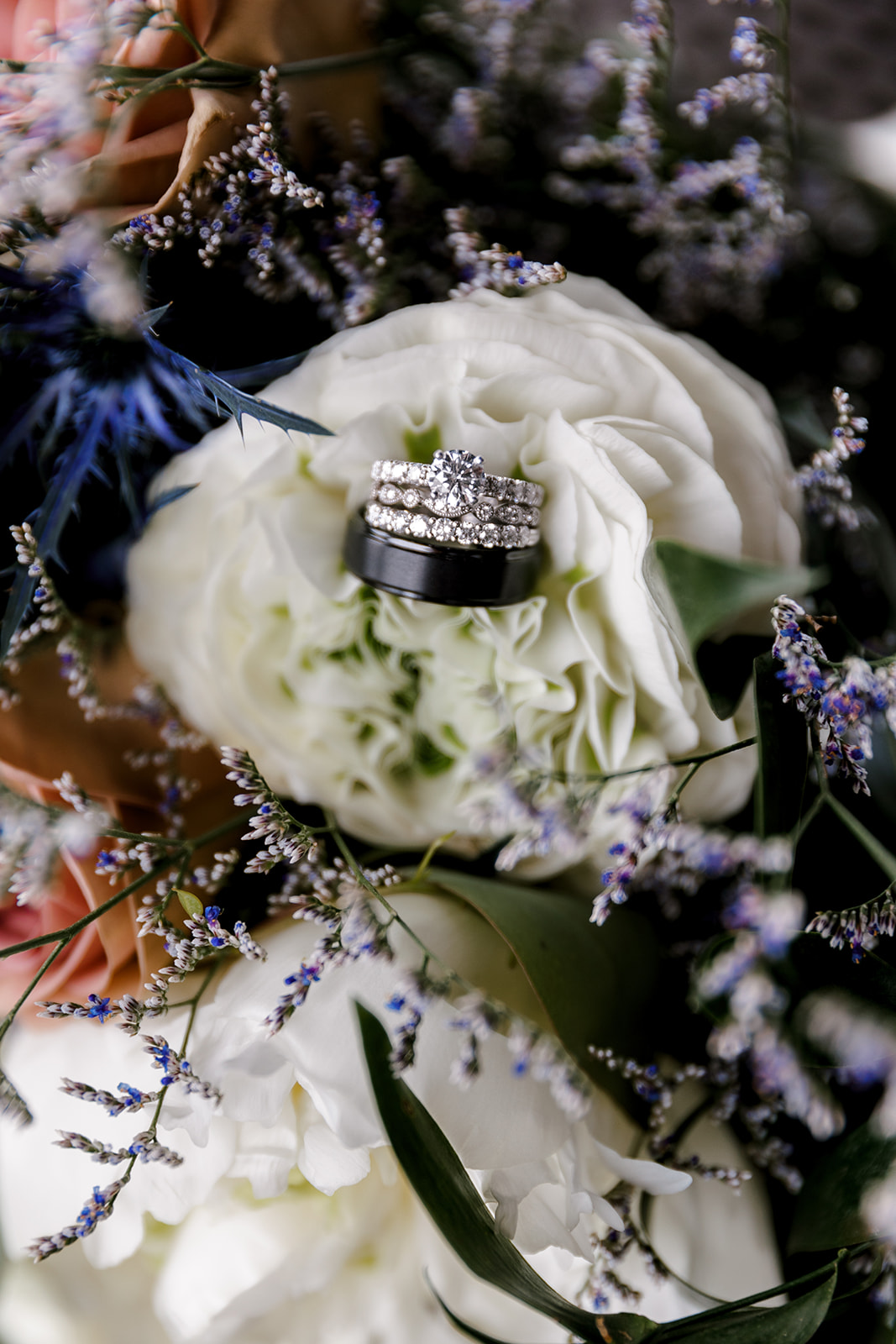 up close shot of wedding rings in a flower with Michigan wedding photographer Port 393 Wedding In Holland, Michigan | Allie + Ryan