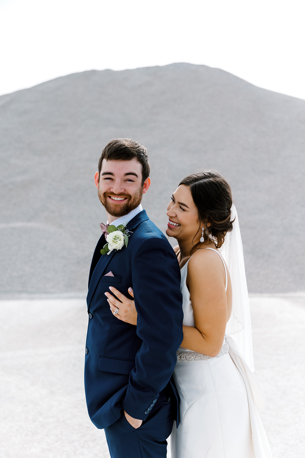 bride hugging groom from behind Port 393 Wedding In Holland, Michigan | Allie + Ryan