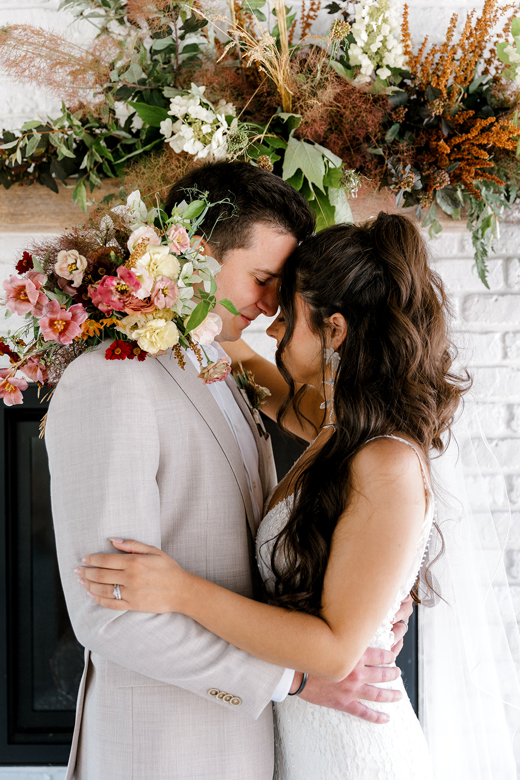 bride and groom hugging during their wedding photos with bridal bouquet