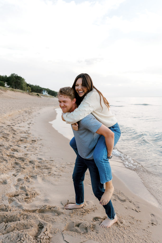 Playful engagement session at Oval Beach in Michigan