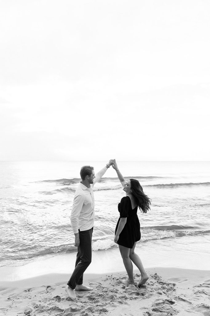 Couple dancing on the beach during engagement session