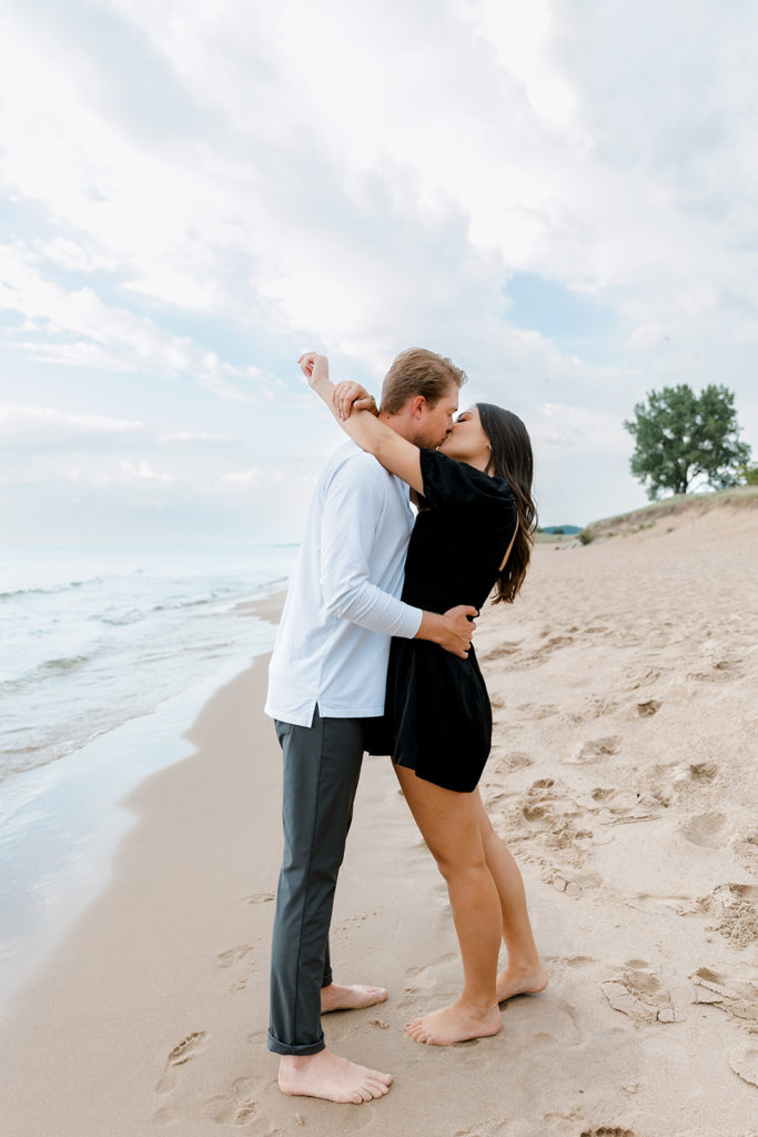 Couple walking the beach during engagement session 