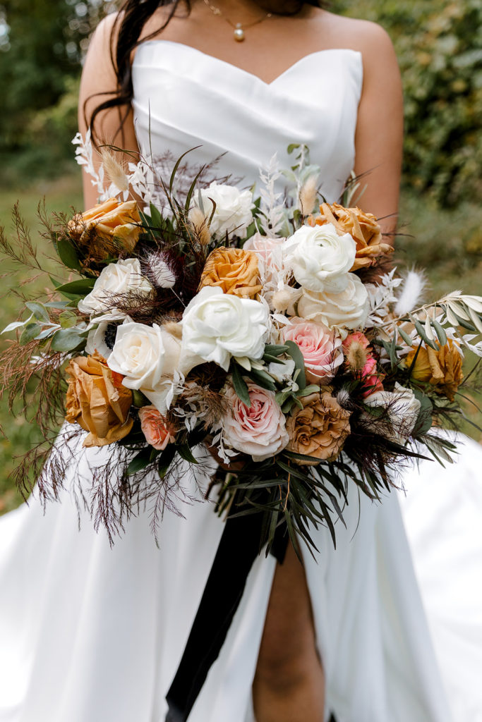 bride posing with wedding flowers bouquet 