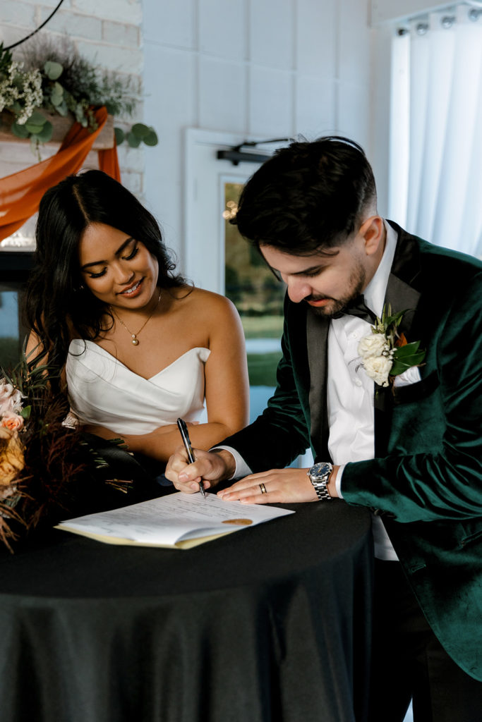 bride and groom signing marriage license