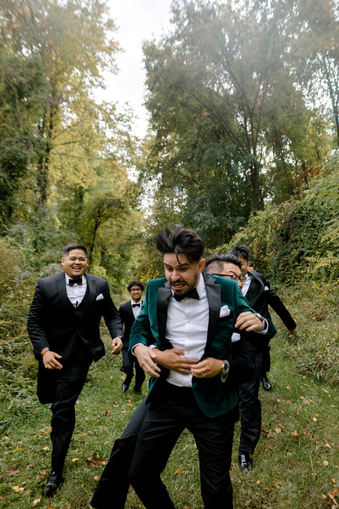 groomsman tackling groom during bridal party photos