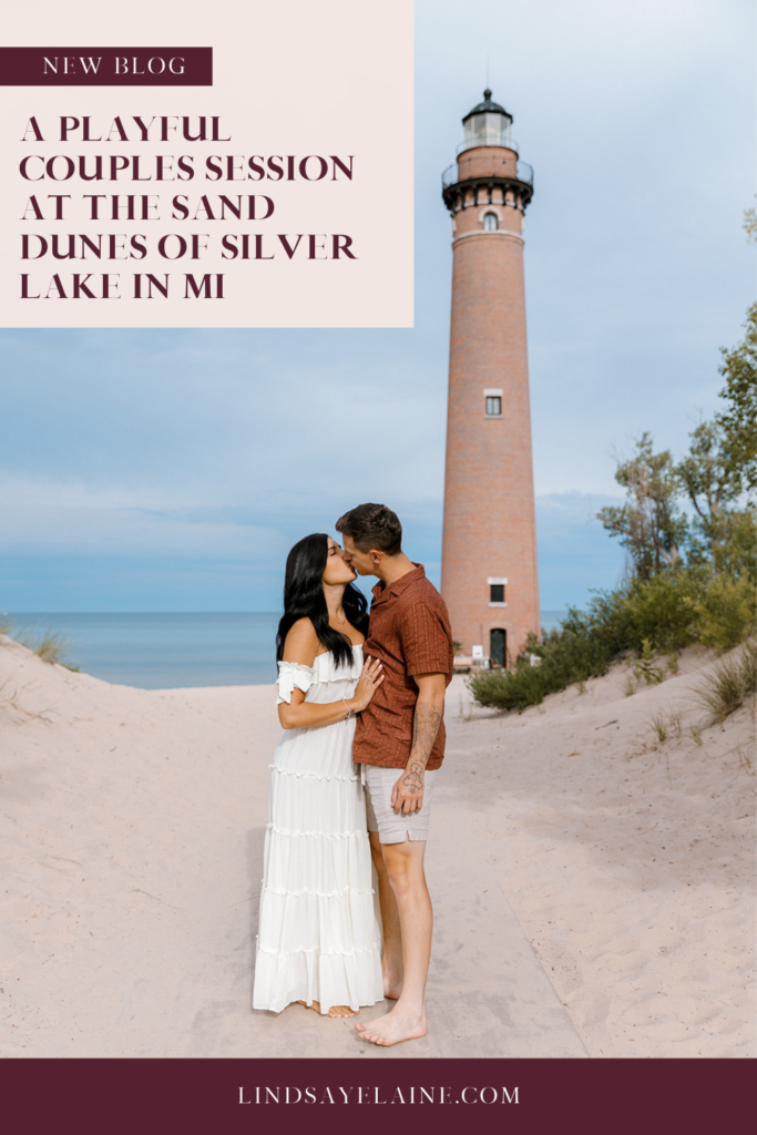 couple kissing in front of little sable point lighthouse in mi