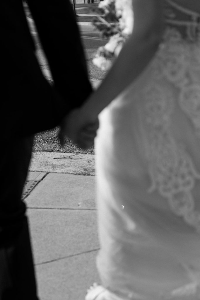 Bride and groom walking and holding hands