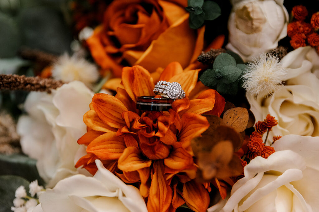 Wedding ring and band on flower bouquet