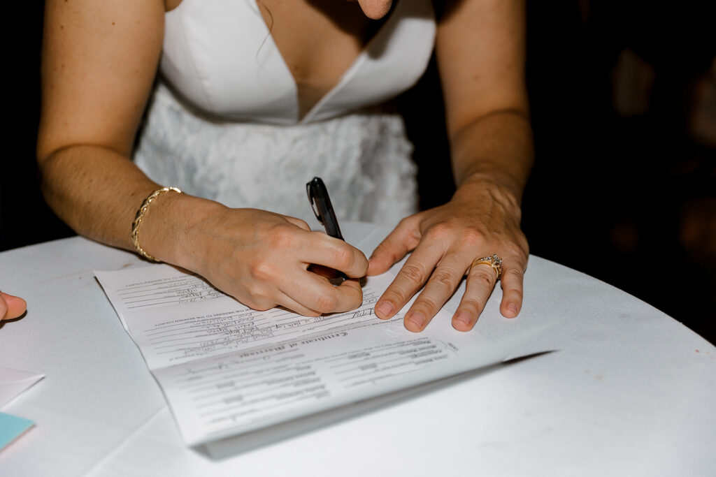 bride signing marriage license