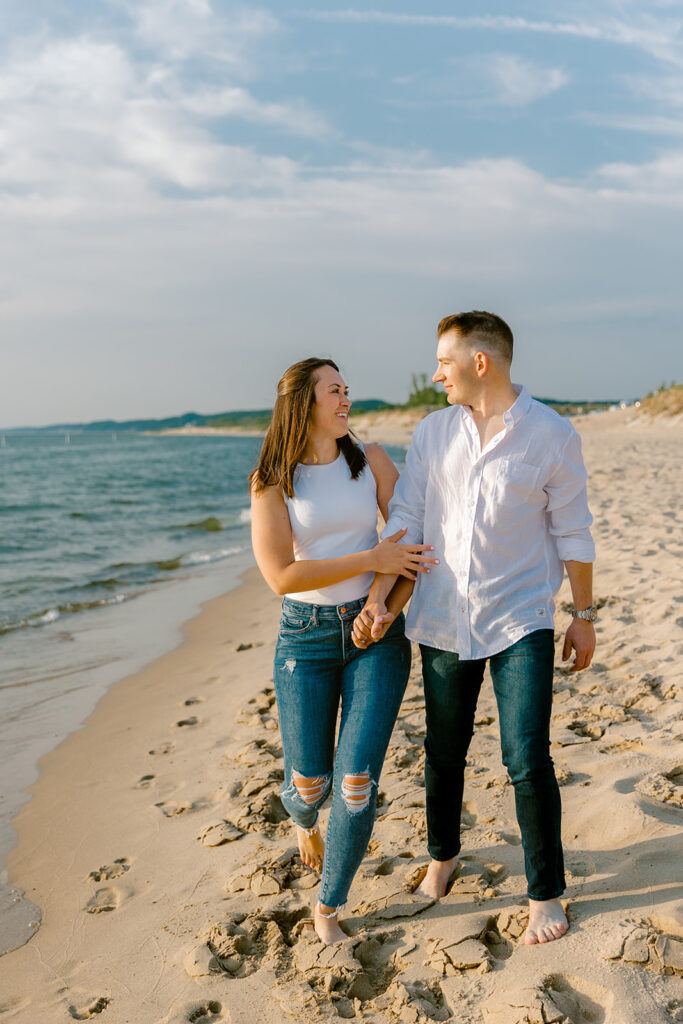 Couples romantic engagement photos at Oval Beach in Saugatuck