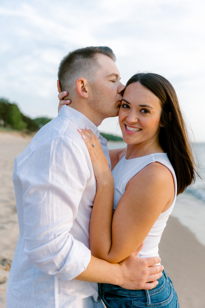 Couples romantic engagement photos at Oval Beach in Saugatuck