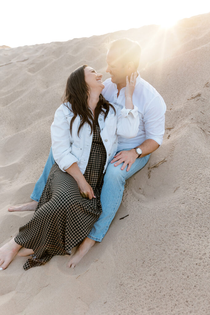 Sunset beach engagement photos at Oval Beach on a retro boat 