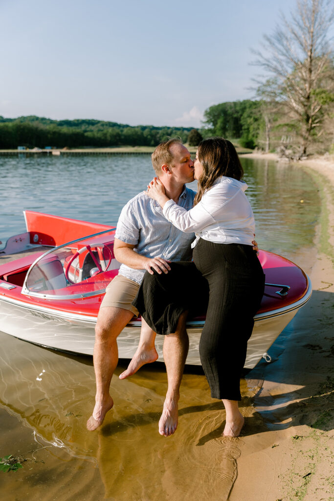 Sunset beach engagement photos at Oval Beach on a retro boat 