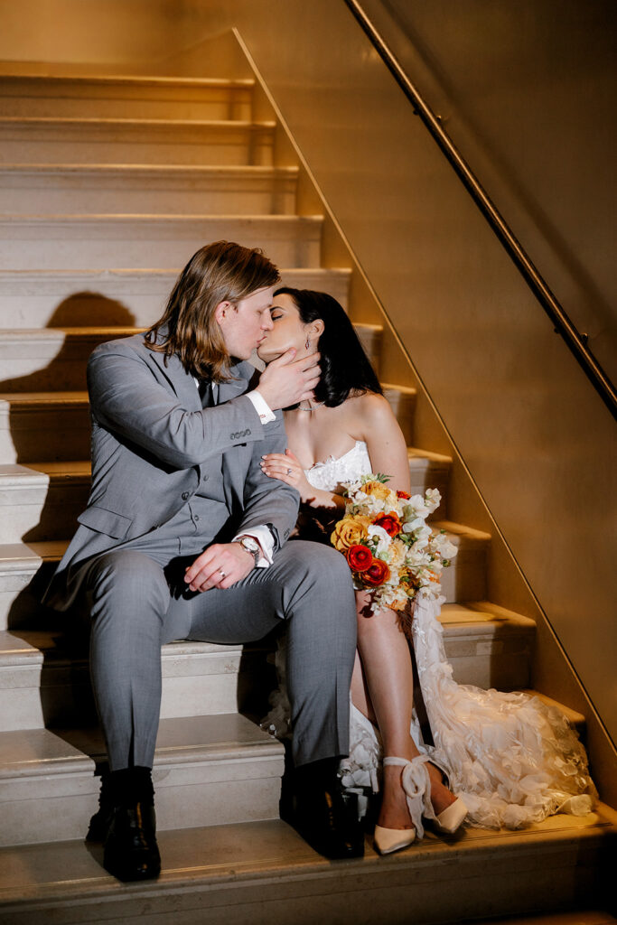 Bride and groom kiss in stairwell of downtown Detroit wedding venue Book Tower at Anthology Events