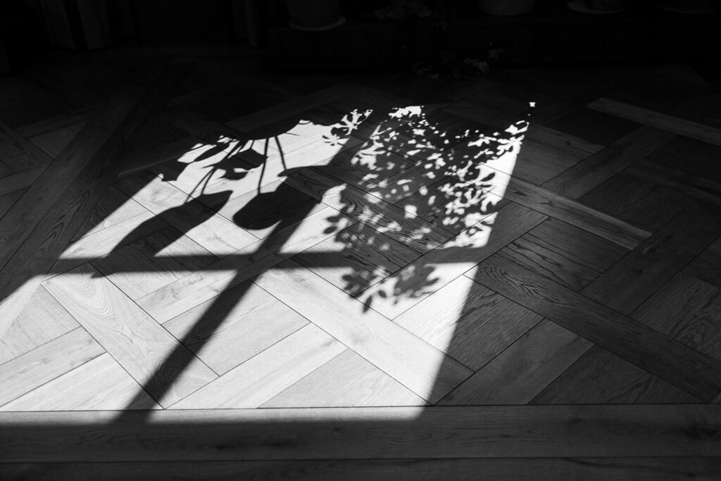 Sunlight casts shadows on luxe wooden floor of downtown Detroit wedding venue