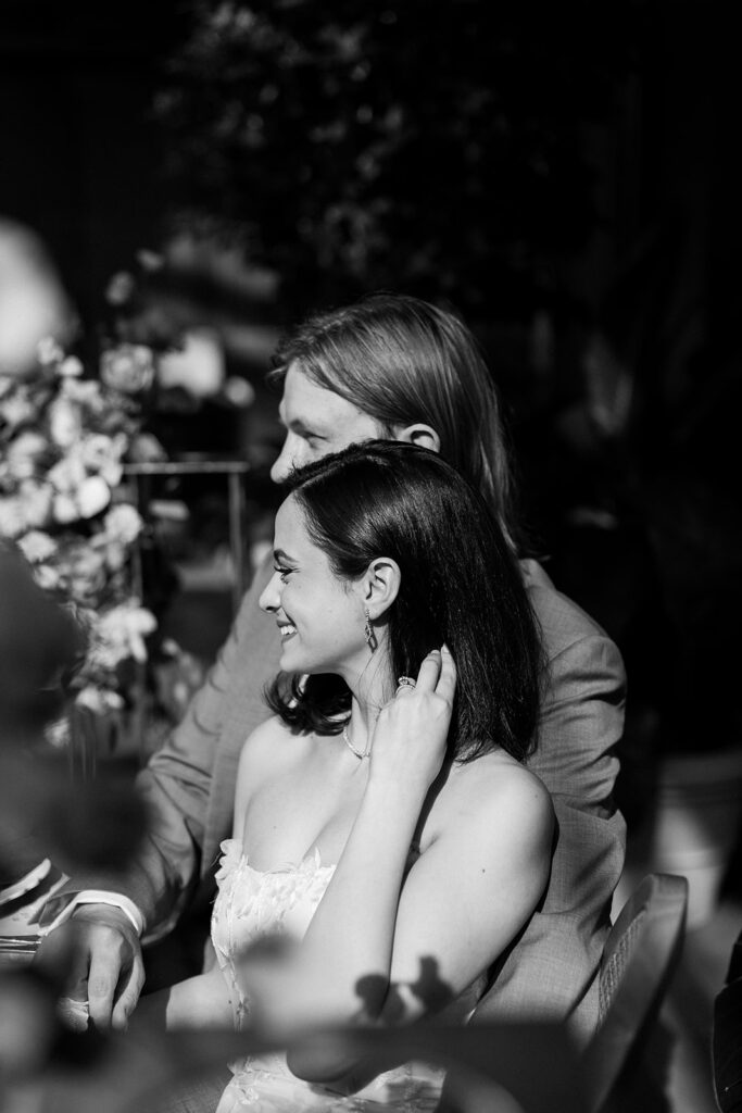 Bride and groom listen to speeches at wedding reception in Detroit