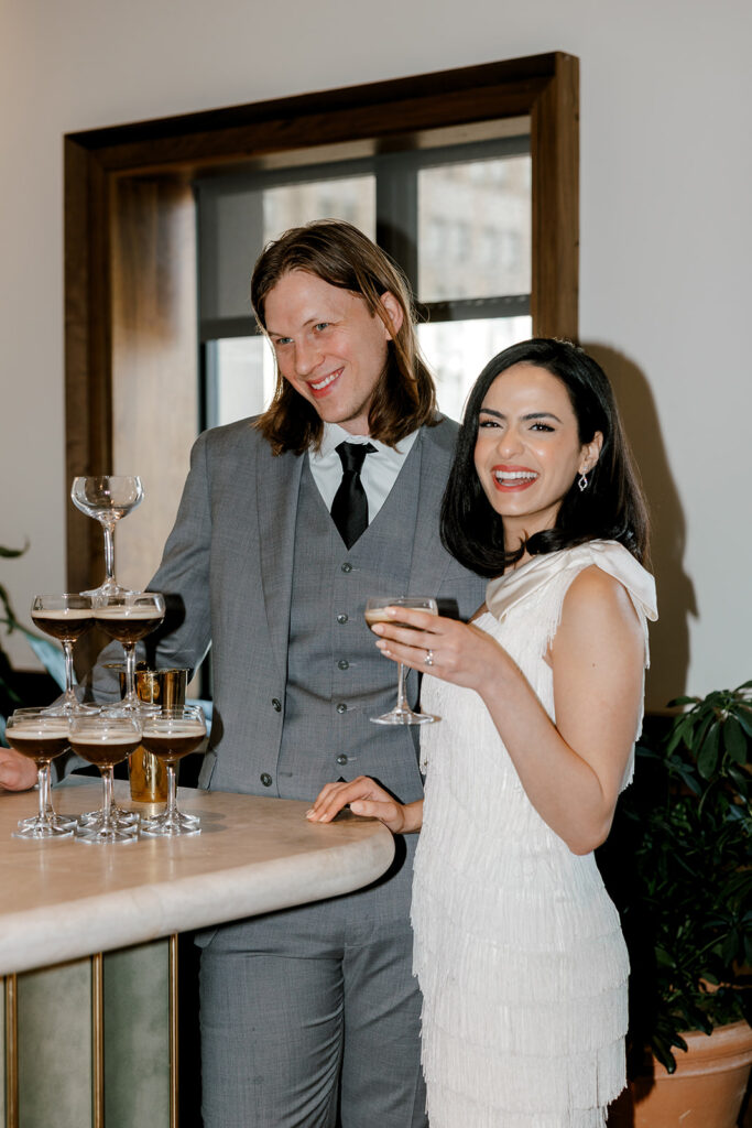 Bride laughs while sipping an espresso martini at mocha-themed wedding