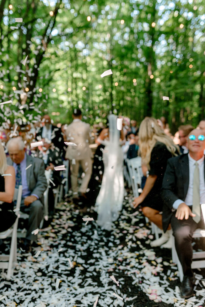 Confetti is caught in the air as newlyweds leave their ceremony
