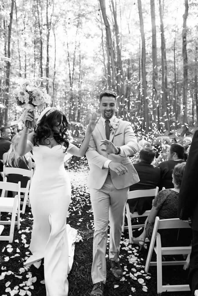 Bride and groom celebrate their matrimony as they come down the aisle to confetti and cheers