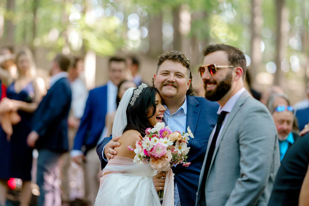 Editorial style candids of bride hugging her wedding guests following the ceremony
