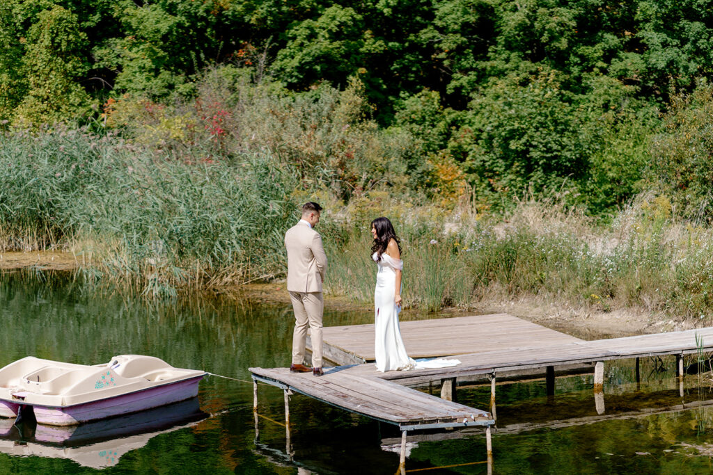 Bride and groom share emotional first look on secluded dock at Bay View at Gallagher Farms