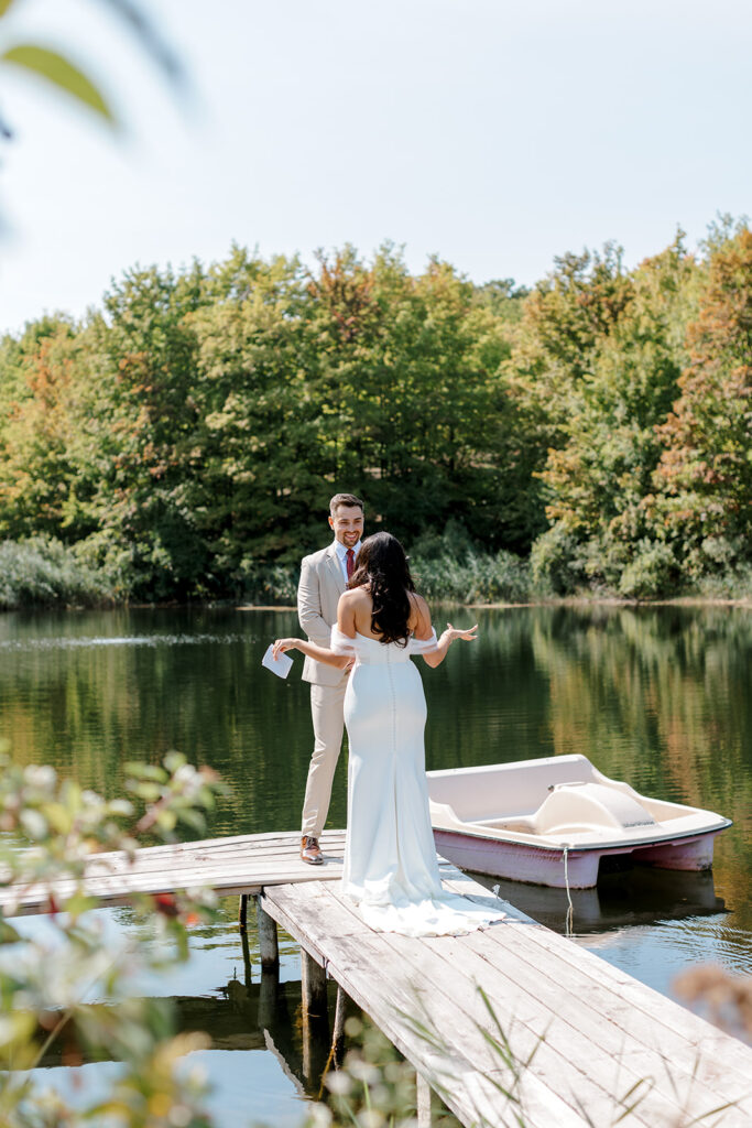 Bride shows off her dress in editorial style candids during first look in Michigan wedding