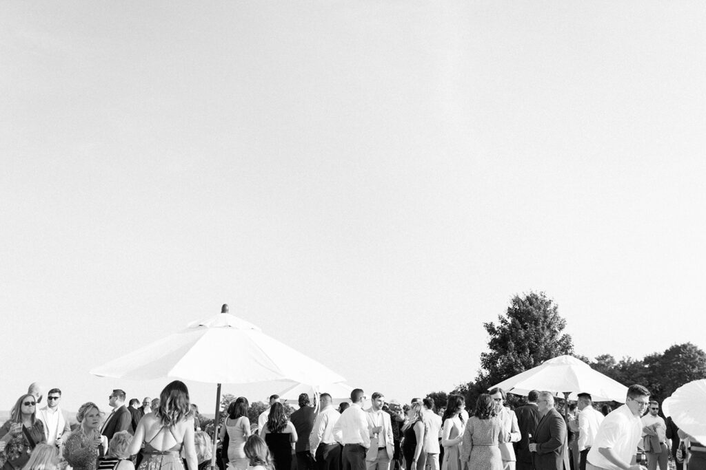Editorial style candids at Michigan wedding cocktail hour at Bay View at Gallagher Farms