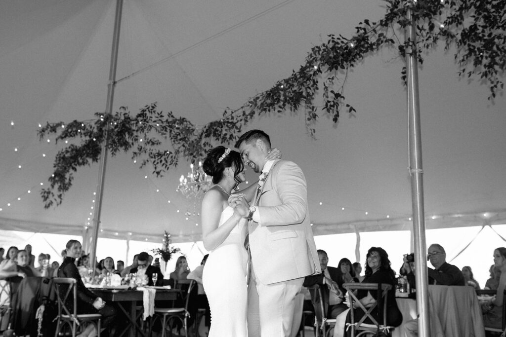 Bride and groom share intimate first dance under cover of tent at Michigan wedding