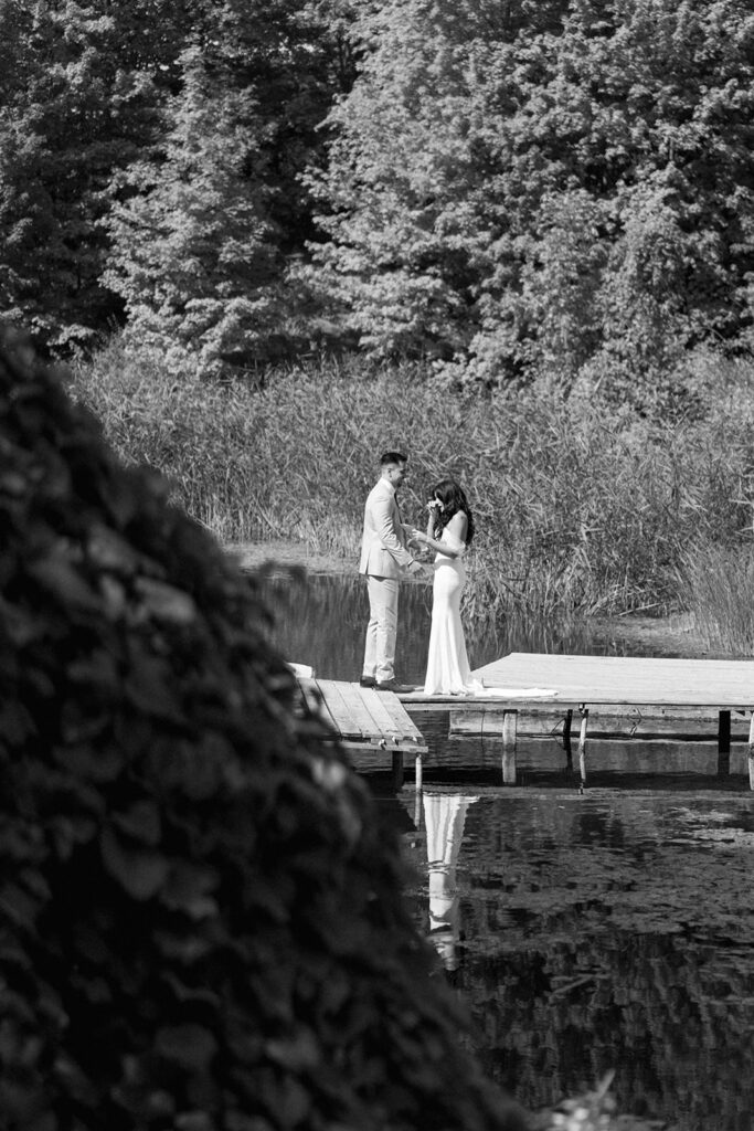 Bride and groom share intimate moment reading vows at Michigan wedding