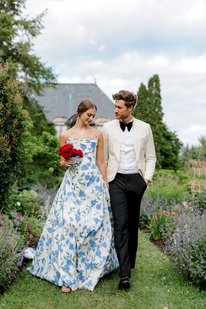A couple shares a quiet moment beneath tall French-inspired windows at European style wedding venue