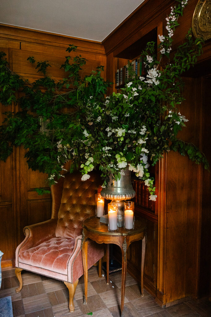 Rich mahogany corner of manor library adorned in white roses at European style wedding venue