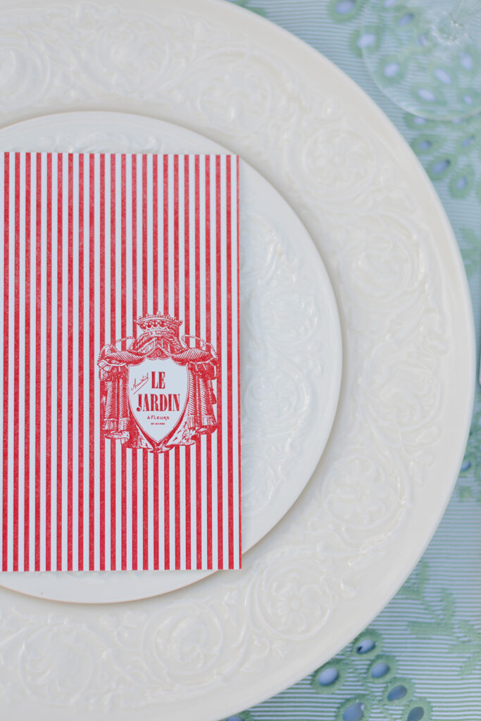 French-inspired custom menus with white embossed china