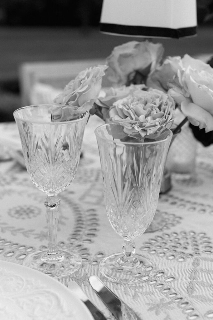 Mixed glassware on welcome party tablescape at European style wedding venue