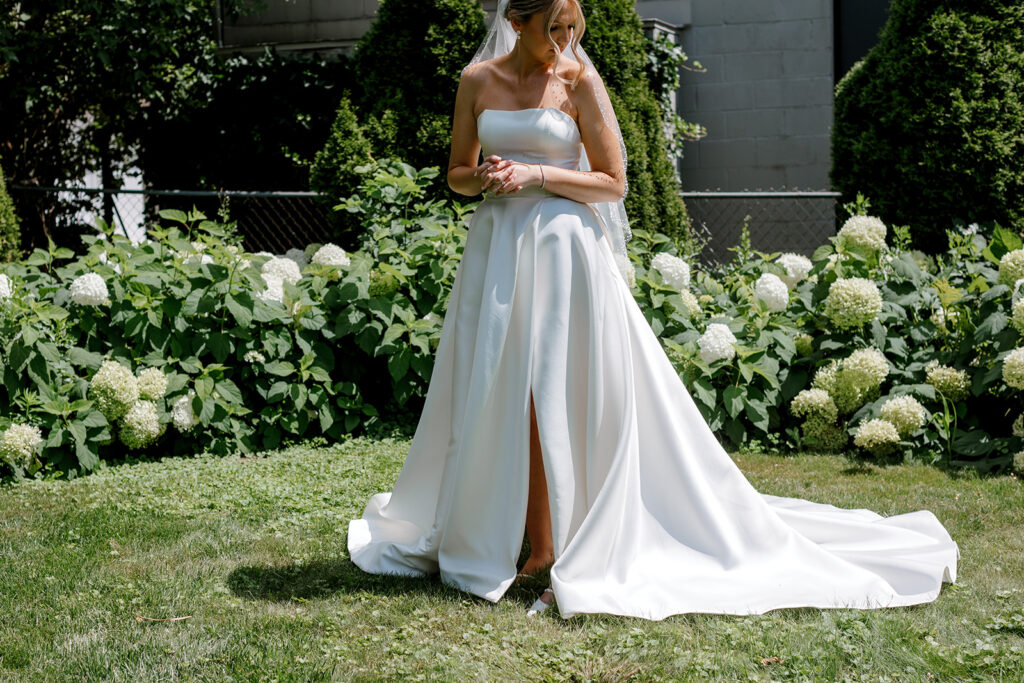 Bride waiting in the garden for first look, a tender moment captured as part of a meaningful wedding shot list.