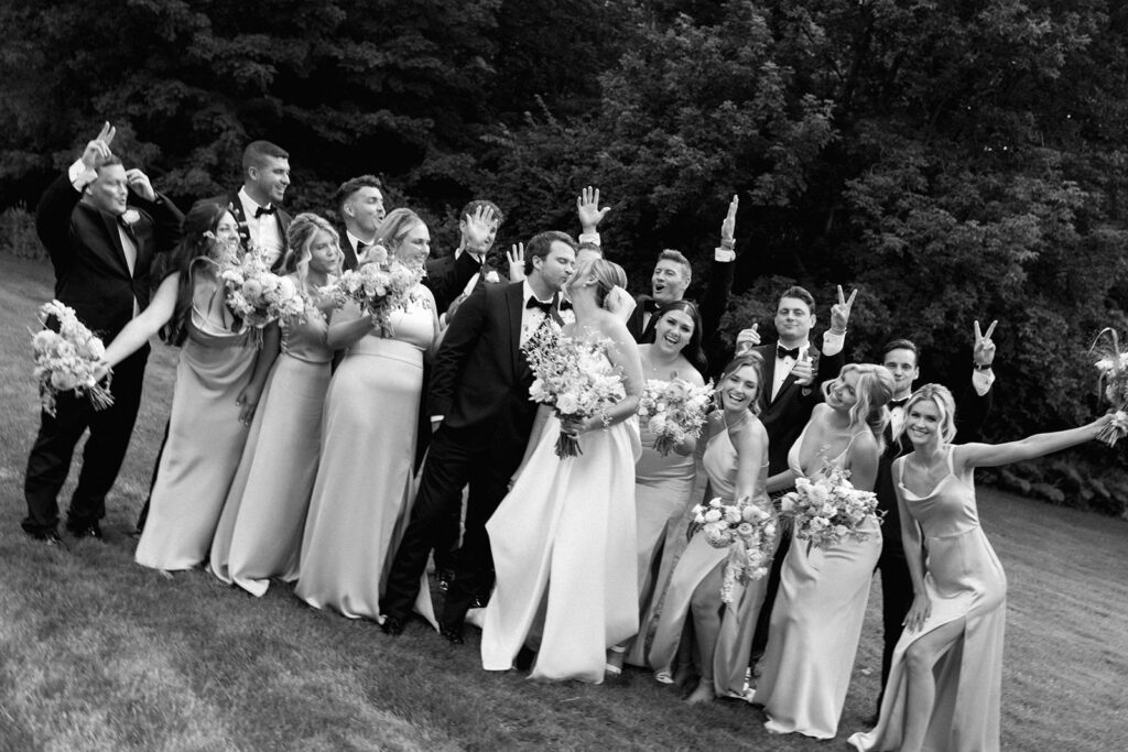 Wedding party cheering and laughing, an example of documentary-style wedding guest photos full of personality.