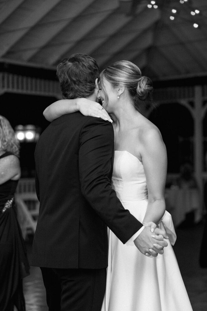 Bride and groom sharing a slow dance, an emotional and intimate reception photo.